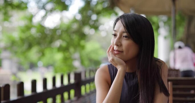 Woman think of something at outdoor cafe