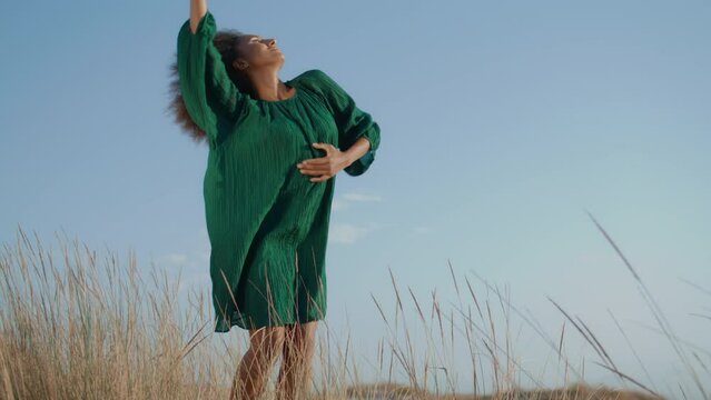 Girl dancer improvising desert making graceful hands movements on summer evening
