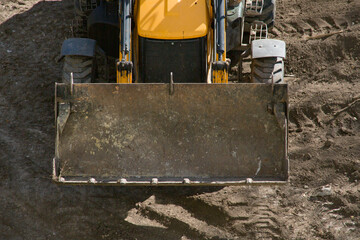 Bulldozer works on earthworks at a construction site. Bulldozer at the construction site during...