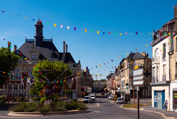 Picturesque summer view of streets decorated with festive garland of small colorful triangular...