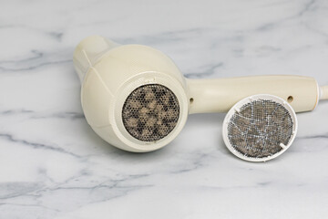 Hair dryer air filter dirty with lint. Blow dryer safety, maintenance and repair. - obrazy, fototapety, plakaty