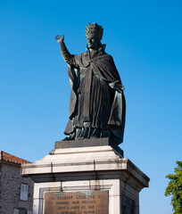Statue of Pope Sylvester II, medieval scholar and clergyman in French city of Aurillac on sunny...