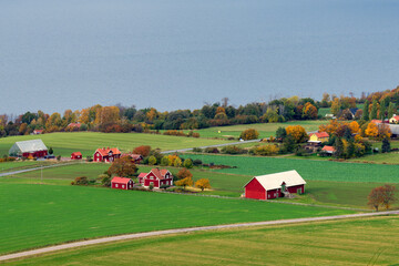 Typical Swedish countryside with red wooden houses by Sweden's second largest lake Vattern.