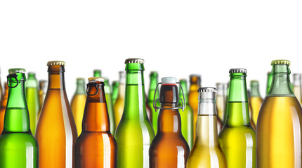 Collection of beer bottles without labels, isolated
