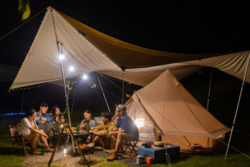 Group of Happy Asian people enjoy and fun outdoor lifestyle camping together on holiday travel...