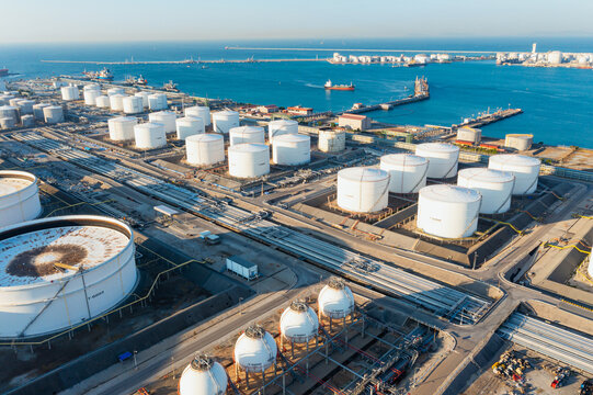 Aerial top view of White oil tank storage chemical petroleum petrochemical refinery product at oil terminal. Oil terminal storage tank in deep seaport for the international order concept. 