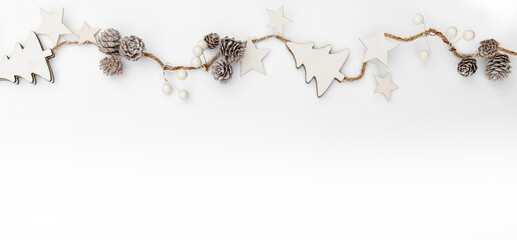 Merry Christmas garland made of white cones, berries, stars on white background. Happy New Year and...