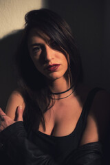 Fototapeta premium Portrait of young woman in black clothes alone outside on the street at night