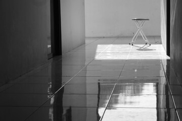 Aluminum chairs in black and white tones with harsh shadows. Loneliness and the concept of...