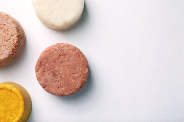 Solid shampoo bars on white background, flat lay. Space for text
