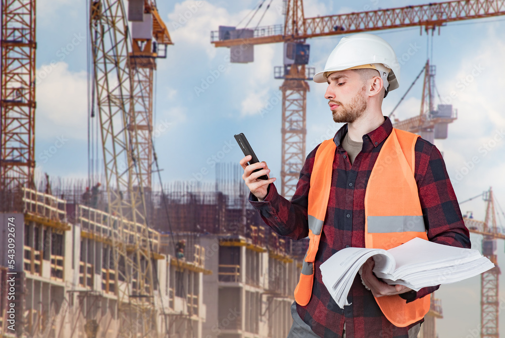 Poster man architect. construction company employee with phone. architect in front of multi-storey building