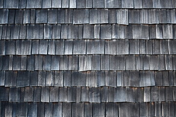 wooden shingled wall, dark in color