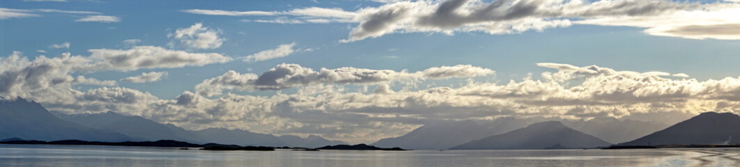 Panorama of the Beagle Channel, outside of Ushuaia, Argentina, under a cloudy, afternoon sky