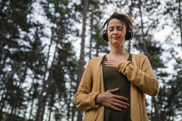 one woman in park or forest online guided meditation self-care concept