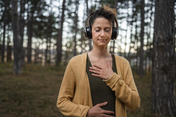 one woman in park or forest online guided meditation self-care concept