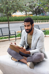 Obraz premium Black man on the street using a tablet