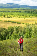 beautiful mature woman traveler enjoys the nature of the southern Urals