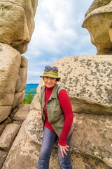 beautiful mature women travels in the ural mountains on the arkul shikhan on a summer day