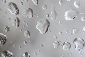 Raindrops Against Car Window After The Storm Against Gray Sky - Macro Photo