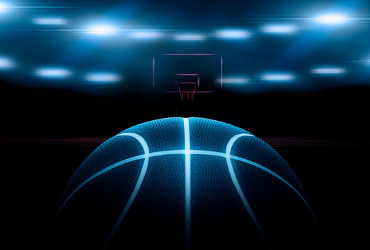3D rendering of single black basketball with bright blue glowing neon lines in under illuminated floodlights. 3d render © supachai