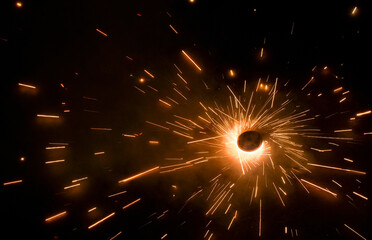 A top view of a type of firework/cracker known as Chakra or Chakri rotating on the ground, during...