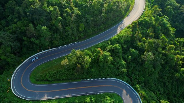 Beautiful winding road "Khong Phab Pha", winding road on the high mountain in Nan, Thailand. Green tropical rainforest. footage of dangerous road. Tourism and the beauty of nature concept. 4K aerial
