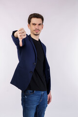 Portrait of young businessman shows sign of dislike, looks with negative expression and disapproval...