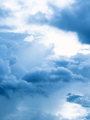 Clouds in the blue sky. Natural sky background texture, beautiful color. Peaceful blue sky with light clouds. The free form beauty of clouds and sky is perfect for background, backdrop and wallpaper.