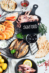 Various of seafood platter - prawn shrimp, squid, octopus mini, salmon, lobster.