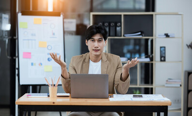 Asian businessman working on computer in office.