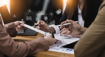 Selective focus of business hands working with document and financial paper during discussion and analytical ideas pointing to the graph at the table office.