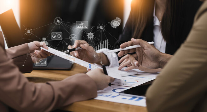 Selective focus of business hands working with document and financial paper during discussion and analytical ideas pointing to the graph at the table office.
