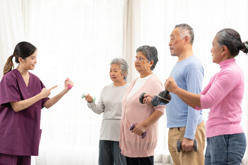 Female asian doctor helping active asian seniors while exercising with dumbbells, sporty...