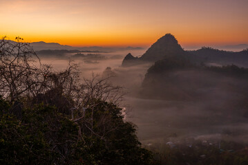 Naklejka premium View of flowing fog on mountain tropical rainforest in the morning