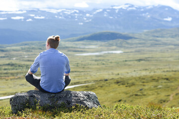 Naklejka na ściany i meble Man viewing the mountain. Picture is taken on Valdresflyi in Norway