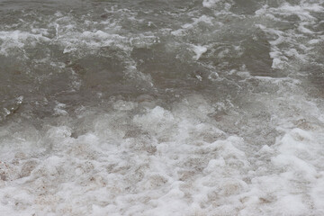 Sea waves crash on the shore.