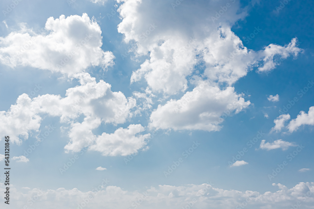 Wall mural a clear sky with a three-dimensional effect due to the harmony between the low clouds and the high c
