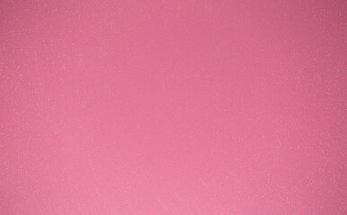 Fototapeta premium Pink background of decorative plaster with abstract spots. Unusual texture of this wall with beautiful patterns, creative surface background. Finishing coating for building cladding.