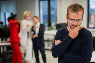 A middle-aged man is upset because of the ridicule of his female colleagues. Discrimination against...