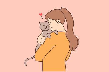 Happy girl hold cat in arms 