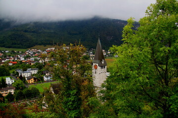 Landscape with a view of the St. Nicholas Catholic Church and the descending fog in the city of...