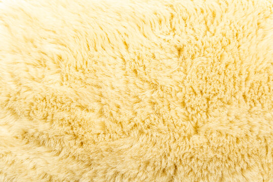 Top view of white soft sheepskin textile plaid. Warm cozy background. High quality photo