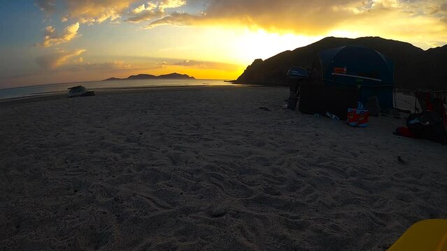 time lapse of bright orange sunset at the beach, punta bufeo, baja mexico