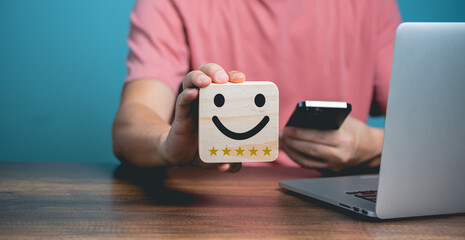 Customer service satisfaction concept, Young businessman using Mobile Phone and holding happy face...