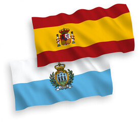 Fototapeta premium National vector fabric wave flags of San Marino and Spain isolated on white background. 1 to 2 proportion.