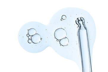 Pipette and drops of cosmetic serum for the skin. Liquid body care product. Isolated on a white background.