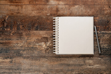 Vintage sketchbook with pen mockup. Notebook or sketchbook with pen mockup. Top view on blank brown...