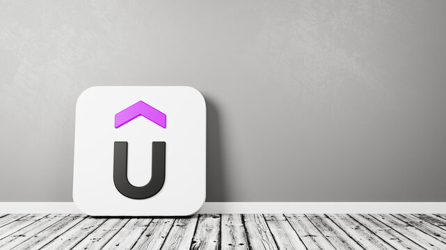 Udemy App Icon on Wooden Floor Against Wall