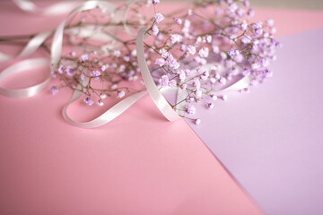Pink tablet for text with a background of white flowers and ribbon