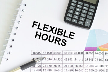 FLEXIBLE HOURS text on notepad on chart with keyboard and calculator on a grey background